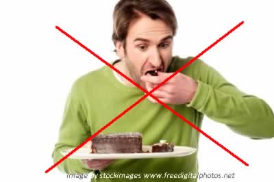 Man eating cake red cross